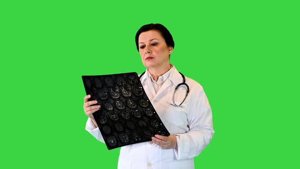 Senior Female Radiologist Examining Brain Scan Mri on a Green Screen Chroma Key