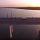 Aerial Shot of Large Bridge with a Moving Minibus at Golden Sunset in Summer - VideoHive Item for Sale