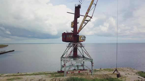 An Old Abandoned Rusty Crane in the Seaport