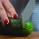 Women cuts a cucumber with a knife - VideoHive Item for Sale