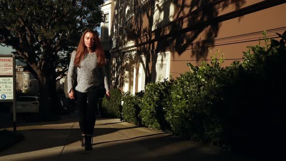 Woman walking in residential city street