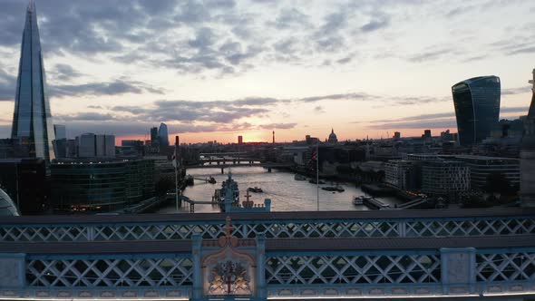 Backwards Fly Above River Thames Flowing Through City in Sunset Time