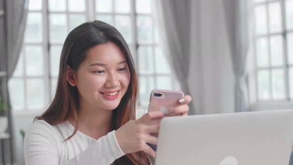 Asian Girl Enjoy With Smartphone During Work From Home