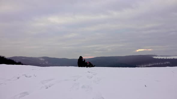 Hiker drink tea from thermos after a day hike