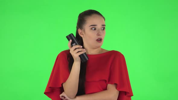 Portrait of Pretty Young Woman with TV Remote in Her Hand, Switching on TV. Green Screen