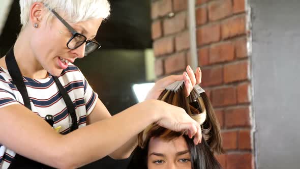 Female hairdresser styling customer hair