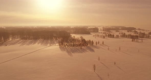 Aerial View of Cold Winter Landscape Arctic Field Trees Covered with Frost Snow Ice River and Sun