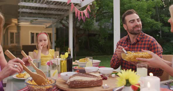 Three generation family enjoying lunch outdoors