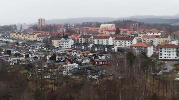 Living district of private and apartment buildings in Swedish town on moody day, aerial orbit shot