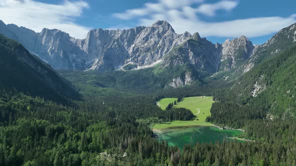 Emerald lake at Fusine with Mangart mountain