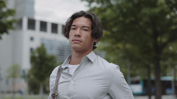 Portrait of Asian Businessman Posing in City Street