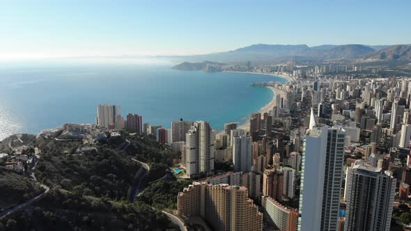 Aerial footage of Benidorm Playa Levante beach, hotels, buildings and restaurants