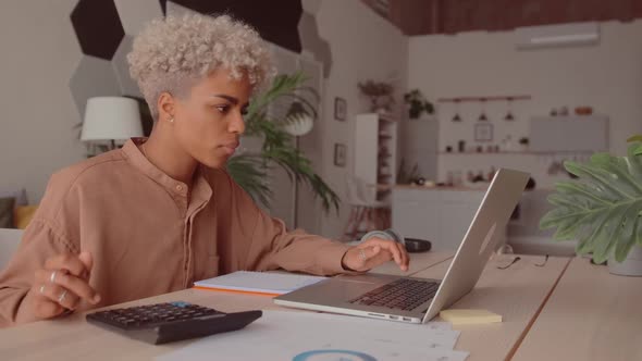 African Woman Manage Budget Calculate on Pay Bills Taxes Online on Laptop