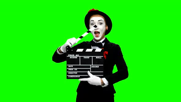 Woman Mime Uses the Movie Clapper on Green Screen