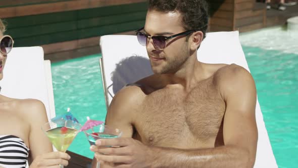 Couple toasting glasses of cocktail