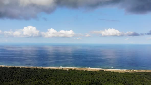 Panoramic view of Baltic Sea Coastline while flying over forest