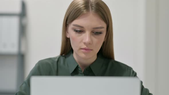 Portrait of Woman with Laptop Looking at Camera 