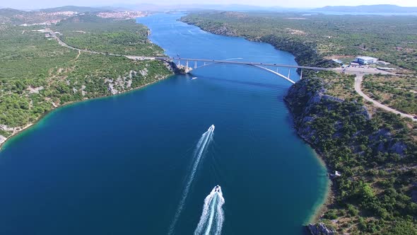 Aerial view of speedboats approaching bridge over dalmatian canal, Croatia