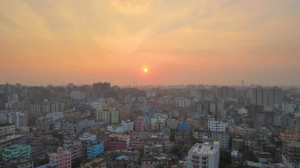 Drone descent revealing Dhaka Khilgaon cityscape of colorful buildings at sunset. Bangladesh in 4K,