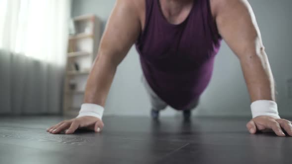 Sweating Plump Man In His 50s Doing Push-ups With Great Effort, Home Training