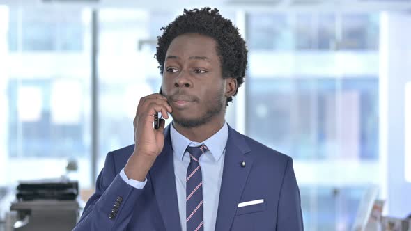 African American Businessman Shouting While Talking on Cellphone
