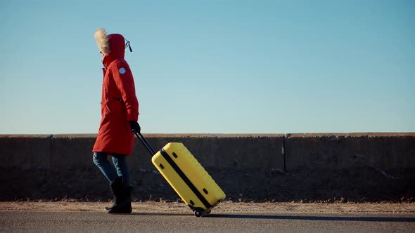 Tourist Travelling Mood. Walking With Yellow Travel Bag. Traveler Transportation With Suitcase.