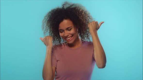 Charming Cheerful Beautiful African American Positive Woman Showing Thumbs Up