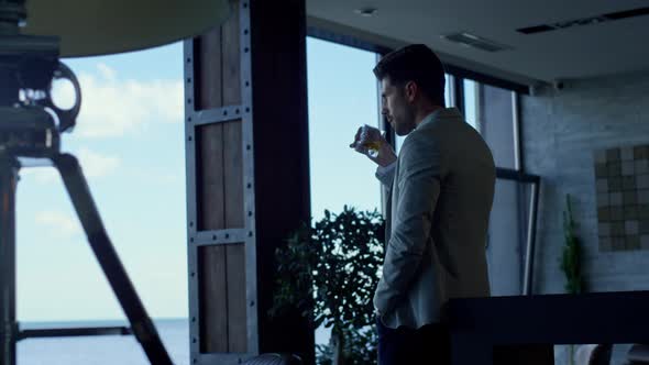 Businessman Drinking Whiskey in Hotel Lounge