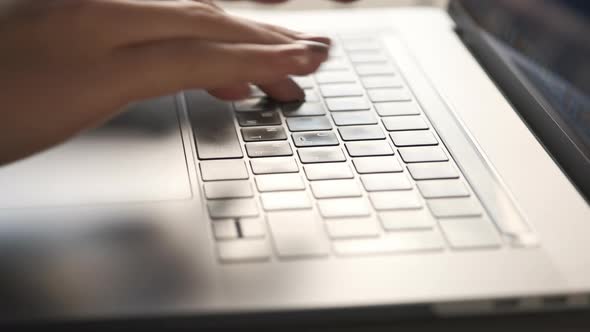 Close Up View. Female Hands Typing Text on Laptop