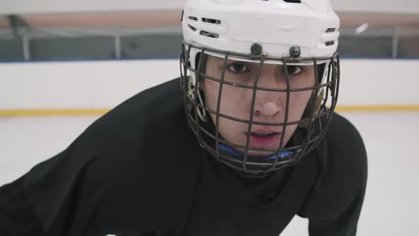 Portrait Of Young Hockey Player In Helmet With Cage