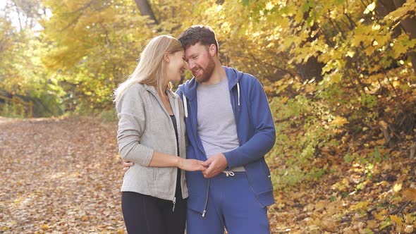 Caucasian Couple Happy Together Young Couple Enjoying Each Other in the Autumn Forest on a Sunny Day