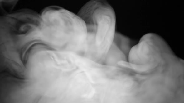 White smoke on black background, slow motion