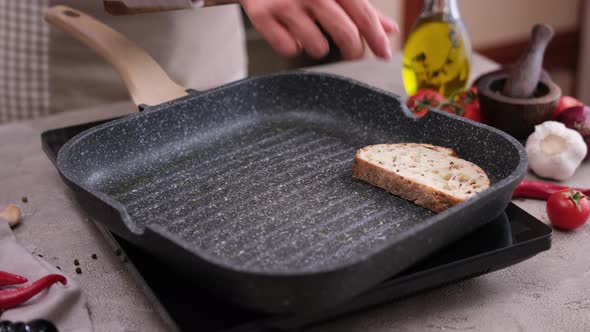 Toasting Slices of Baguette in a Grill Frying Pan