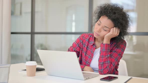 Tired African Woman Taking Nap While Sitting with Laptop