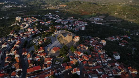 A drone pushes in towards the flag on top of Belmonte Castle