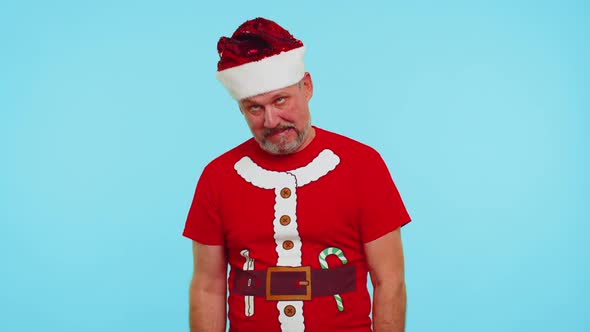 Crazy Man in Santa Christmas Tshirt Hat Demonstrating Tongue Out Fooling Around Making Silly Faces