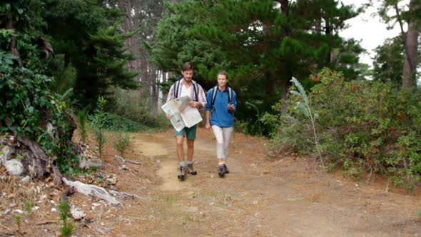 Couple of hiker looking a map and compass