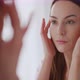 Woman Examining Perfect Skin Near Mirror - VideoHive Item for Sale