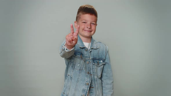 Toddler Lovely Boy Showing Victory Sign Hoping for Success and Win Doing Peace Gesture Smiling