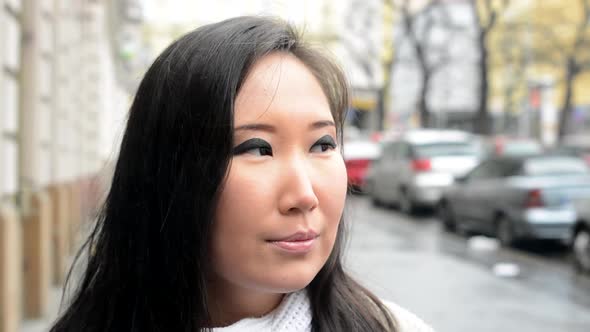 Young Attractive Asian Woman Smokes - Urban Street with Cars - City - Closeup