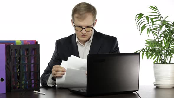 Businessman Working in Office. Manager Talking on Telephone. Analyzing Paperwork