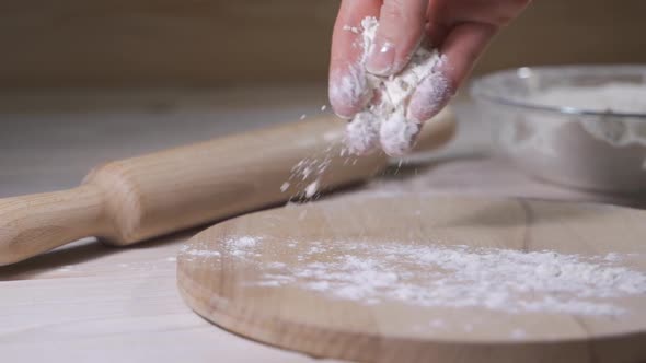 Hand of Baker Kneading Dough for Pizza Preparation. Chef Cook Making Dough for Baking Cake on Wooden