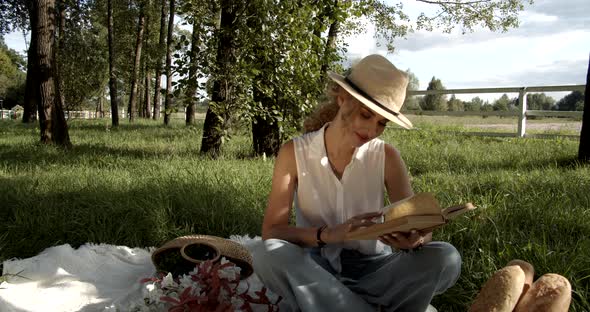 Beautiful Young Girl Came On A Picnic And Reads An Interesting Book