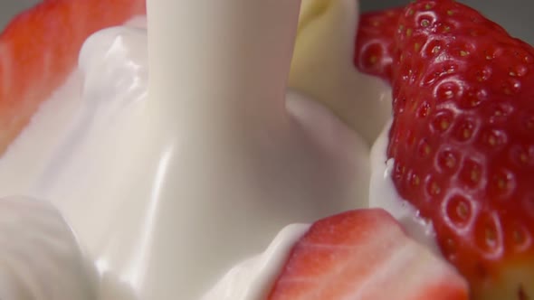 Strawberry Halves Fall Into Milk