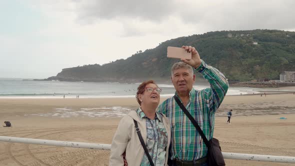 Spanish Retired Couple Taking a Selfie in the City of San Sebastian