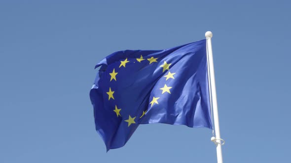 European Union flag rised on white flag-pole waving on wind 4K 2160p 30fps UltraHD footage - Symbol 