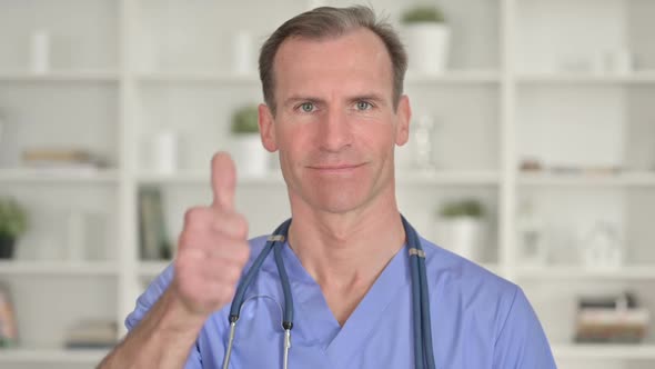 Portrait of Successful Middle Aged Doctor Showing Thumbs Up