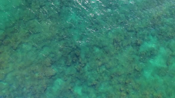 Aerial shot of turquoise Hawaiian waters near Diamond Head.