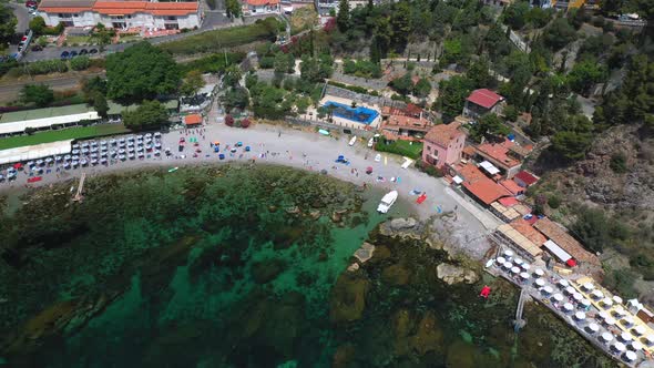 Downward angle drone shot of Isola Bella flying coastline. Near Taormina, Sicily, southern Italy. Al