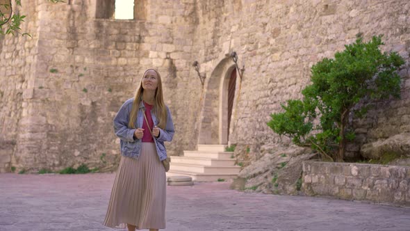 A Young Woman Visits the Old Town of Budva in Montenegro